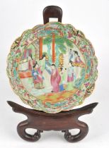 A Canton famille rose bowl, decorated in typical colours with a group of Manchu/Chinese figures in