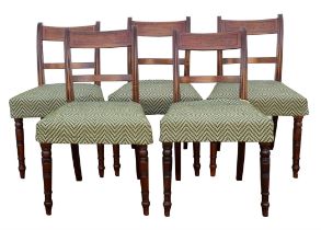 Six George IV mahogany dining chairs, the curved bar backs on reeded supports, the seats on ring