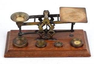 A set of Mordant & Co. London brass postal scales, together with six weights, four inset and two