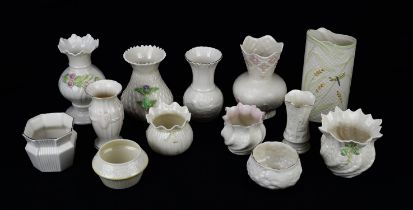 Twenty seven Belleek Parian porcelain vases, in various styles and sizes, the tallest 18cm high (27)