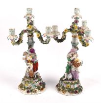 Pair of Sitzendorfer four light candelabra, each with a romantic couple carrying a bird cage and