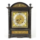 An ebonised wood clock, late 19th/early 20th Century, with ball finials and brass mounted scroll