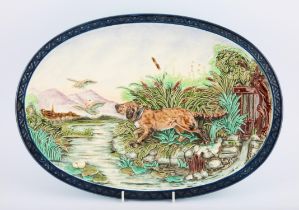 Sarreguemines oval majolica platter depicting a setter chasing ducks, impressed marks,