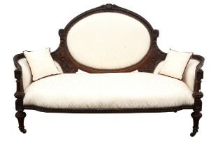 Late victorian walnut sofa with foliate cresting and cable decoration to the arms,