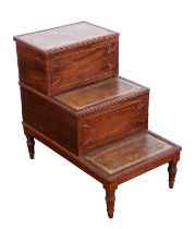 A set of George IV mahogany bed steps, each tread with a leather inset, the upper one hinged,