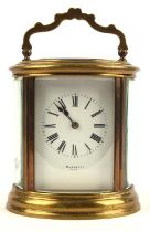 French oval brass and glass carriage clock, the white enamel dial with black Roman numerals signed