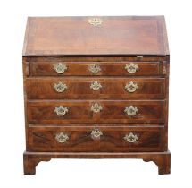 George II walnut bureau, crossbanded and featherbanded, the fitted interior above four long