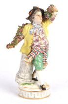 Pair of Meissen figures of a boy and girl, late 19th/early 20th, dressed holding swags of flowers,