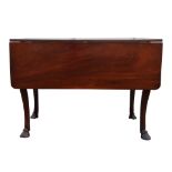 A George III mahogany twin flap dining table, with cabriole legs, terminating in hoof feet,