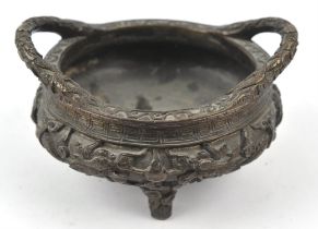 A metal, tripod incense burner with two handles; decorated with dragons in high relief; 16 cm wide;