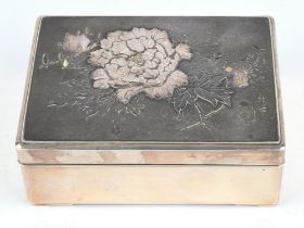 A Japanese white metal kobako, decorated on the cover in kebori and takazogan with a large peony