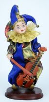 Automaton Jester / Clown with a ceramic head, holding a cello. Working with winder on the back.