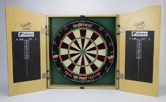 Dartboard in cabinet. Phil The Power Taylor Unicorn board, opens up with scoring boards inside of