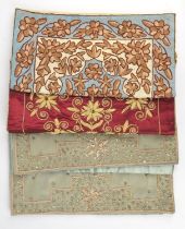 A collection of four hand-embroidered Indian silk and beaded cushion covers embellished with semi