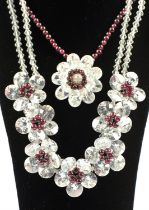 Two Butler and Wilson floral garnet and crystal necklaces, together with a silver garnet ring,