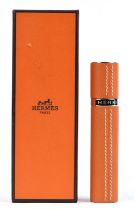 HERMES a boxed and unused leather-cased glass refillable perfume atomiser.