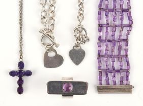 A group of amethyst jewellery, including an amethyst bead bracelet, a ring, and a cross together