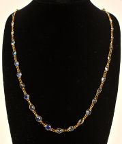 A sapphire gem set necklace, set with round and oval cut sapphires, bezel set with chain link