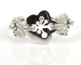 Boodles Blossom ring, triple blossom motif design, with a plain polished blossom in the centre with