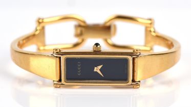 Gucci A Reference 1500 L Ladies gold plated wrist watch,with Gloss black signed dial and gold hands,