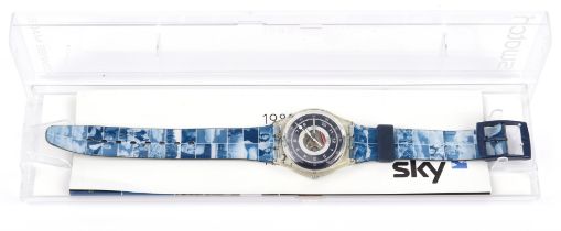 Swatch, a Sky 10th Anniversary wristwatch, blue dial with a window in the centre to reveal the