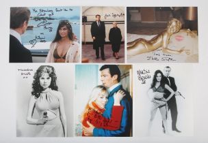 James Bond - Six autographed stills, mostly 8x10 inches. Including Dame Judi Dench, Shirley Eaton,