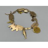 Ladies 9ct gold charm bracelet (7) includes heart, fish and a cross. 17cms 8.84g