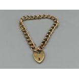 Ladies 9ct gold curb link bracelet with heart padlock, 20cms and 12.81g