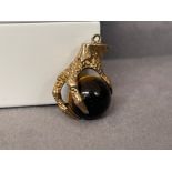 A unusual Eagle Claw Charm hold a tigers eye stone - weighing 5.06 grams