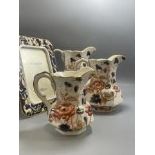 Four pieces of Wedgewood including three jugs all of different sizes and a photo frame