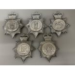 Total of five vintage Police cap/Helmet badges including Warwickshire & Dyfred-Powys Constabulary,
