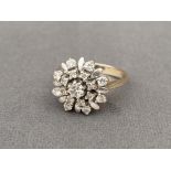 18ct gold diamond cluster ring featuring a .10ct centre stone weighing 4.88 grams Size I