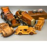 Collection of wooden hand carved model cars, including a card box with vintage metal racing car