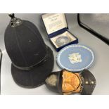Vintage Northumberland Police helmet together with police Bossons wall plaque, also includes