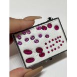 14.32cts of pink and light red stones all of different shades and cuts