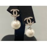 A pair of silver CZ and pearl designer stud earrings, weight 5.02 grams