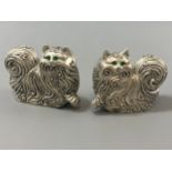 A pair of silver-plated condiments in the form of long-haired cats with emerald eyes, weight 122.