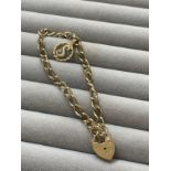 9ct Yellow Gold Love Heart Padlock Bracelet Featuring a S Charm Weighing 8.3 grams and Measuring