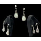 A pair of silver and pear shaped opal drop earrings, weighing 4.20 grams