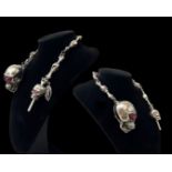 Very substantial and unusual silver albert style watch chain set with skulls, combined weight 88.