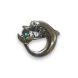 Silver and aquamarine cabochon dolphin brooch set, weighing 8.71 grams