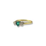 18ct London 1982 yellow and white gold Emerald and diamond trilogy ring featuring an oval emerald