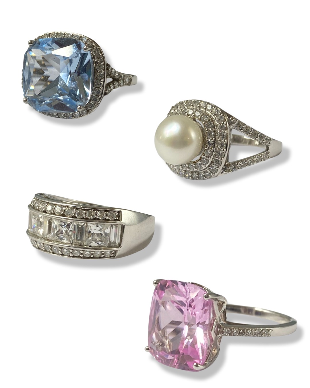 Collection of four silver statement rings all set with different stones and in different styles