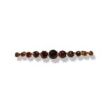 9ct yellow gold garnet bar brooch comprising of 11 round cut garnet weighing approximately 2cts this