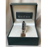 Gucci 1500 L ladies watch with black face and stainless steel band with original box and papers