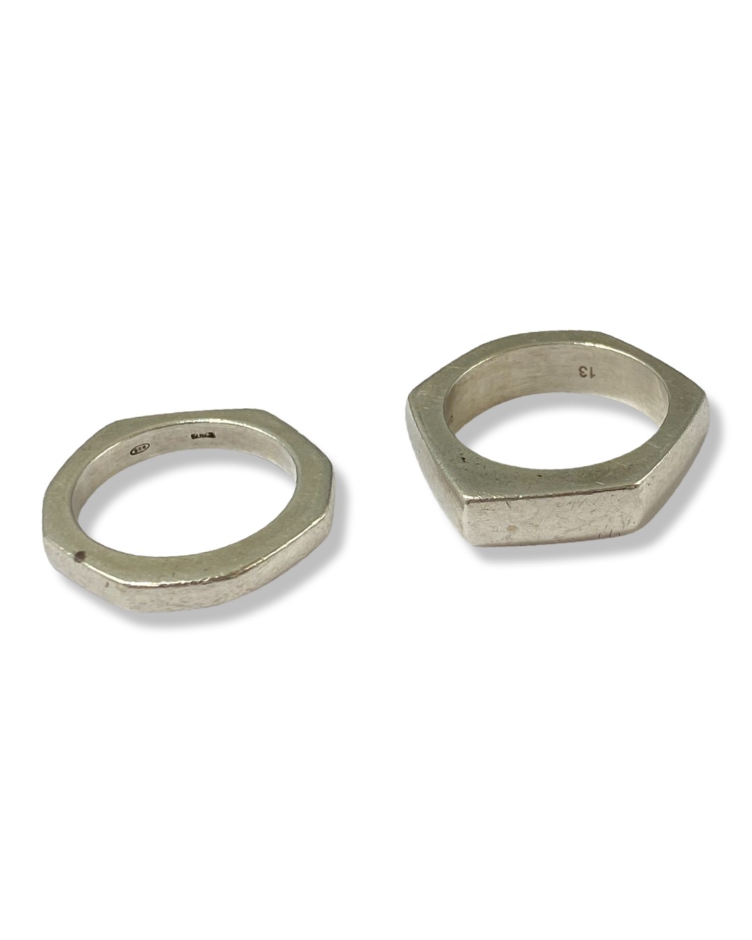 Pair of Gucci silver rings weighing 14 grams collectively, both size M