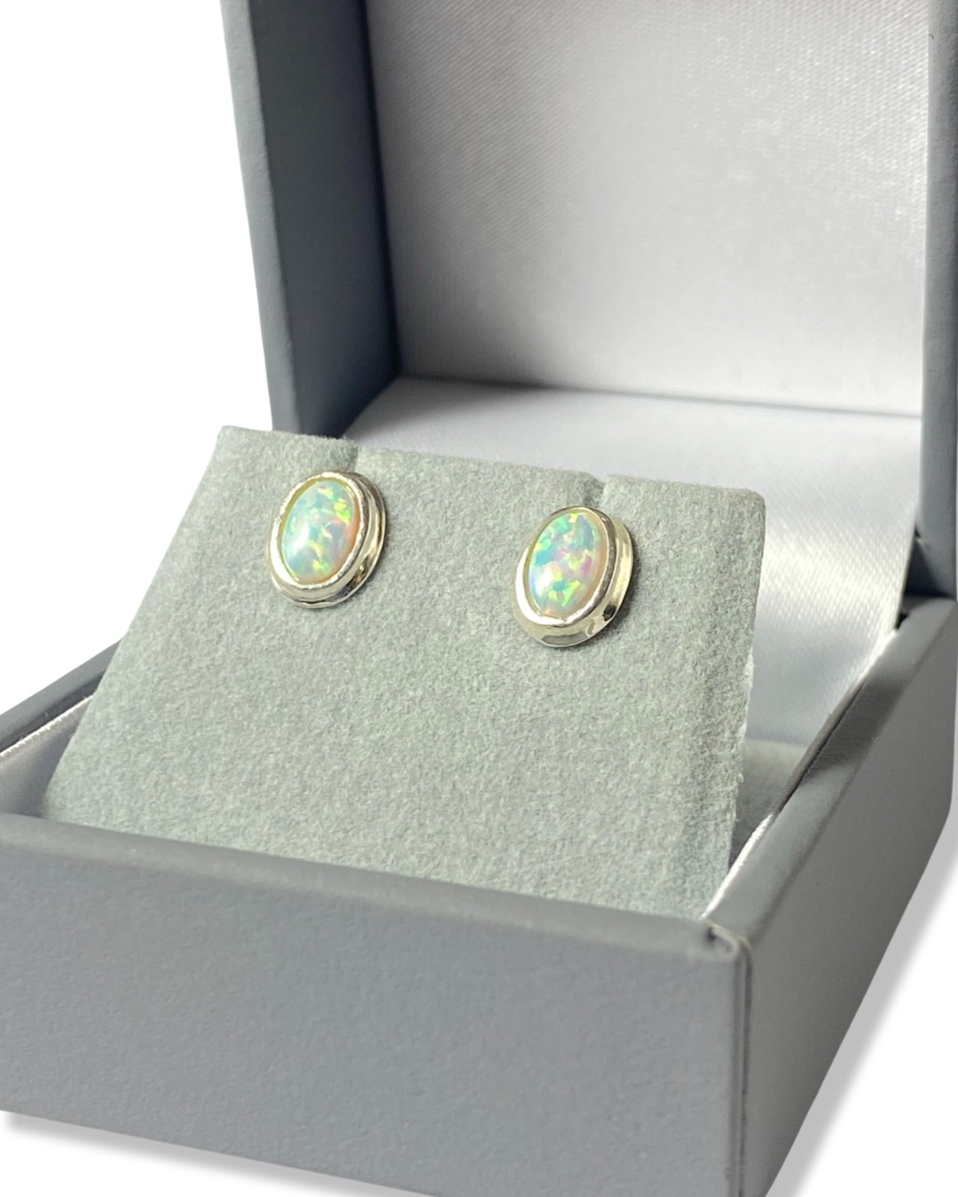 Pair of oval cut opal earrings set in silver mount weighing 0.91 grams