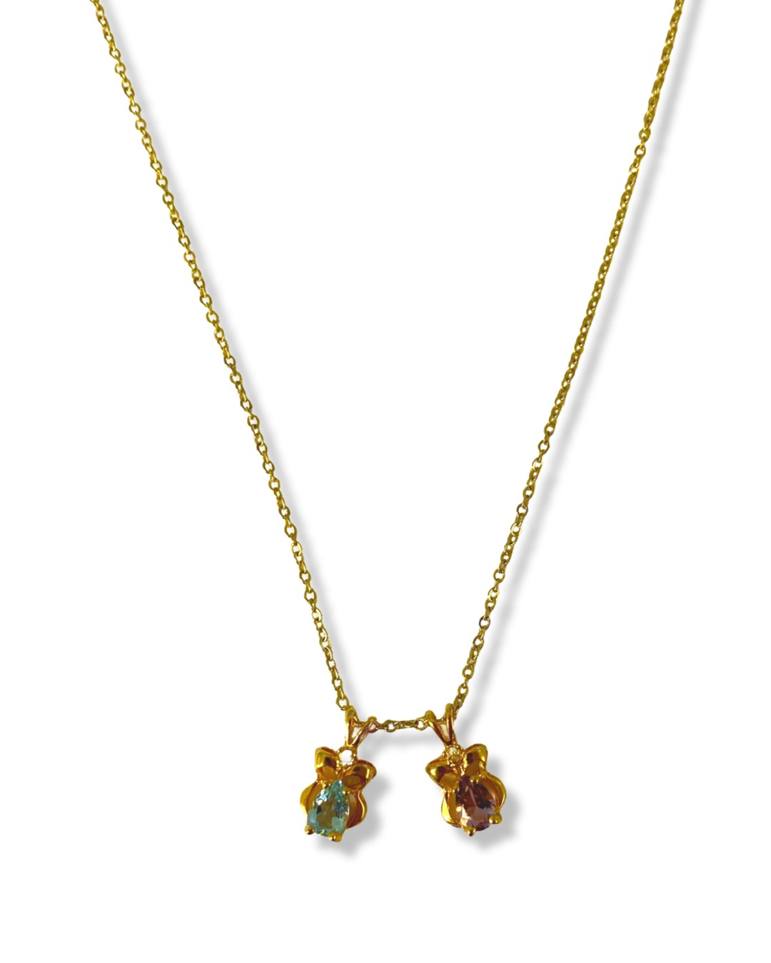 Three gold plated pendants featuring Garnet, Amethyst and Blue Topaz on two gold plated chains, with