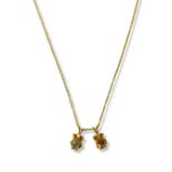 Three gold plated pendants featuring Garnet, Amethyst and Blue Topaz on two gold plated chains, with