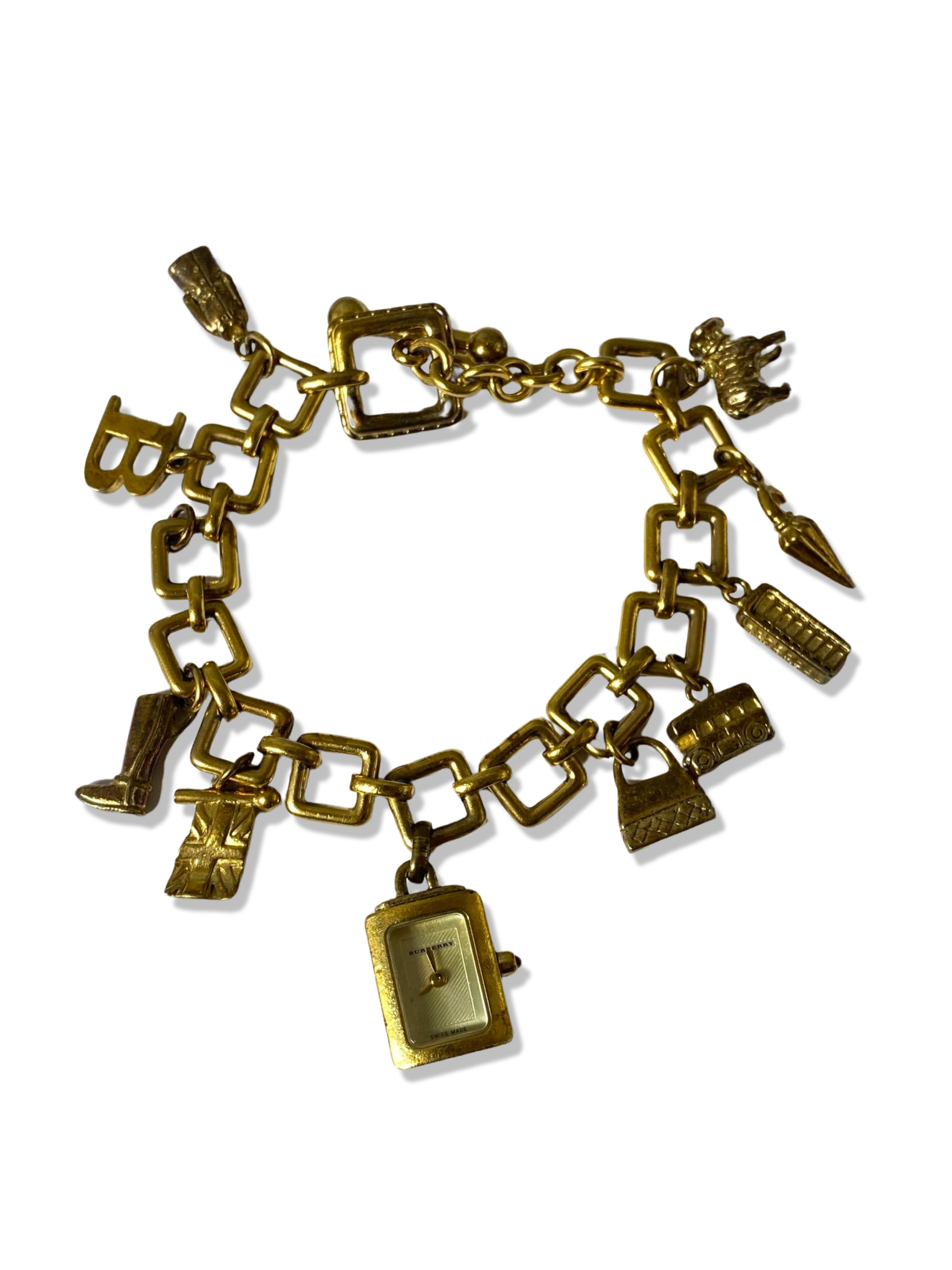 Burberry silver gold tone charm bracelet which includes a working watch charm, weighing 63.03